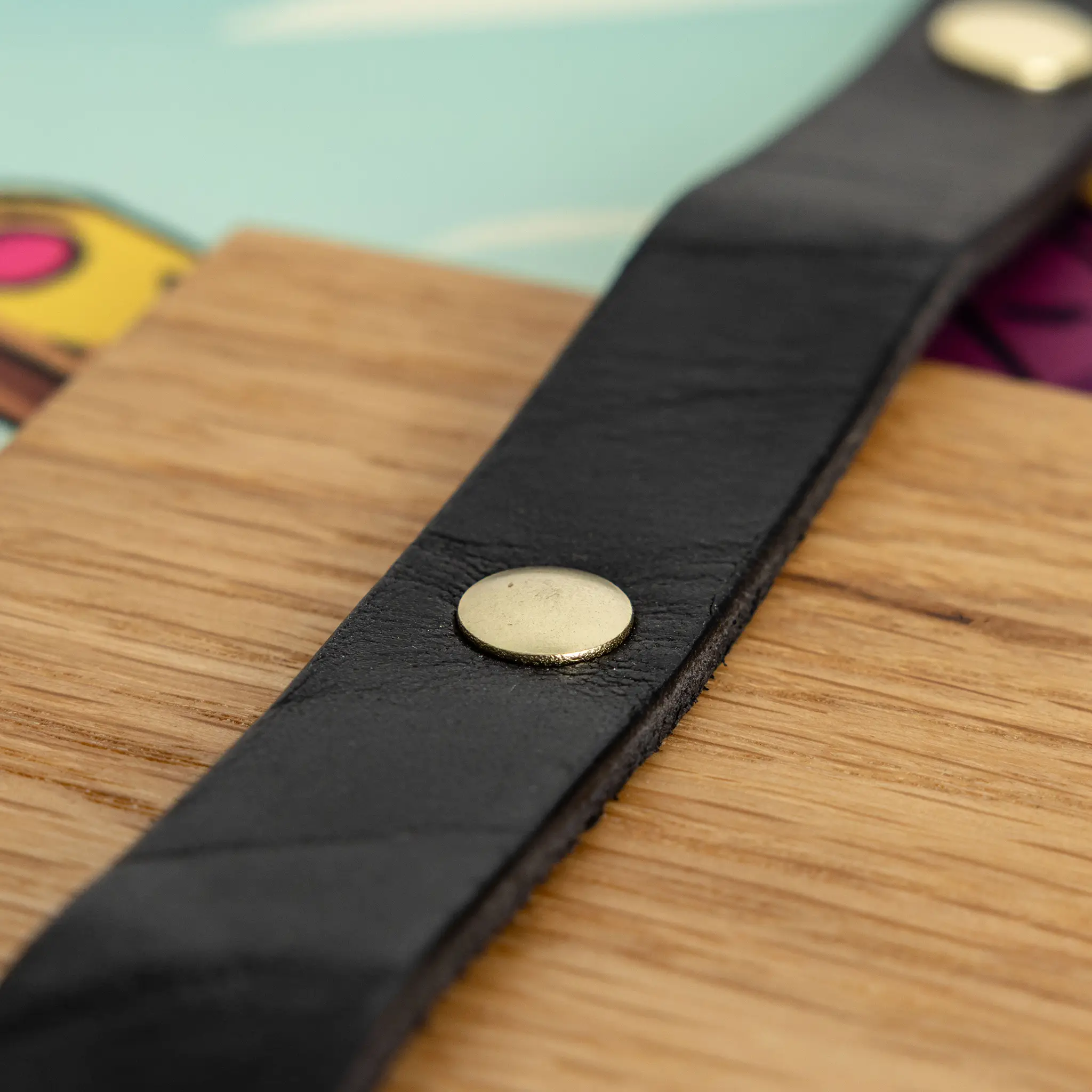 Close-up of latigo leather strap and solid brass snap
